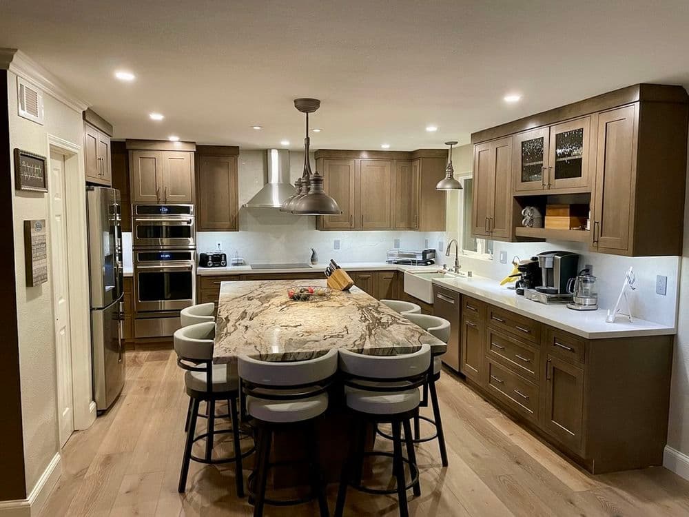 Modern kitchen featuring an island with seating, stainless steel appliances, and stylish cabinetry.