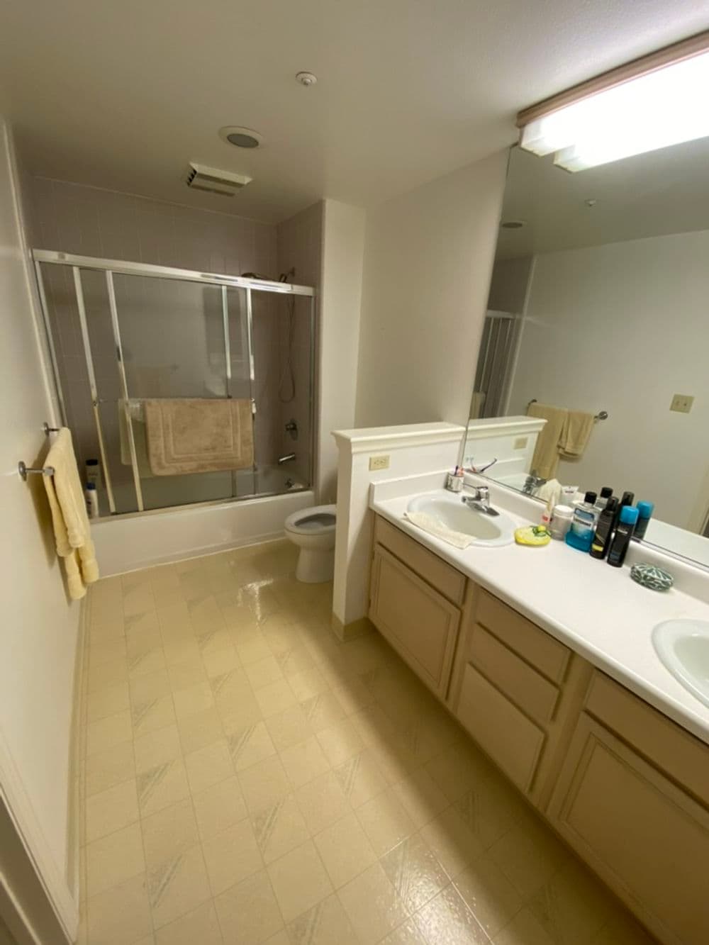 Spacious bathroom with tub, shower, dual sinks, and neutral decor.